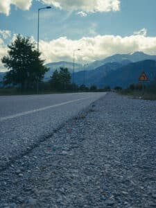empty road to Mount Olympus with cloudy blue sky above