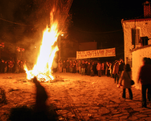 People standing around Burning Cedar fire in Litochoro, Pieria region.