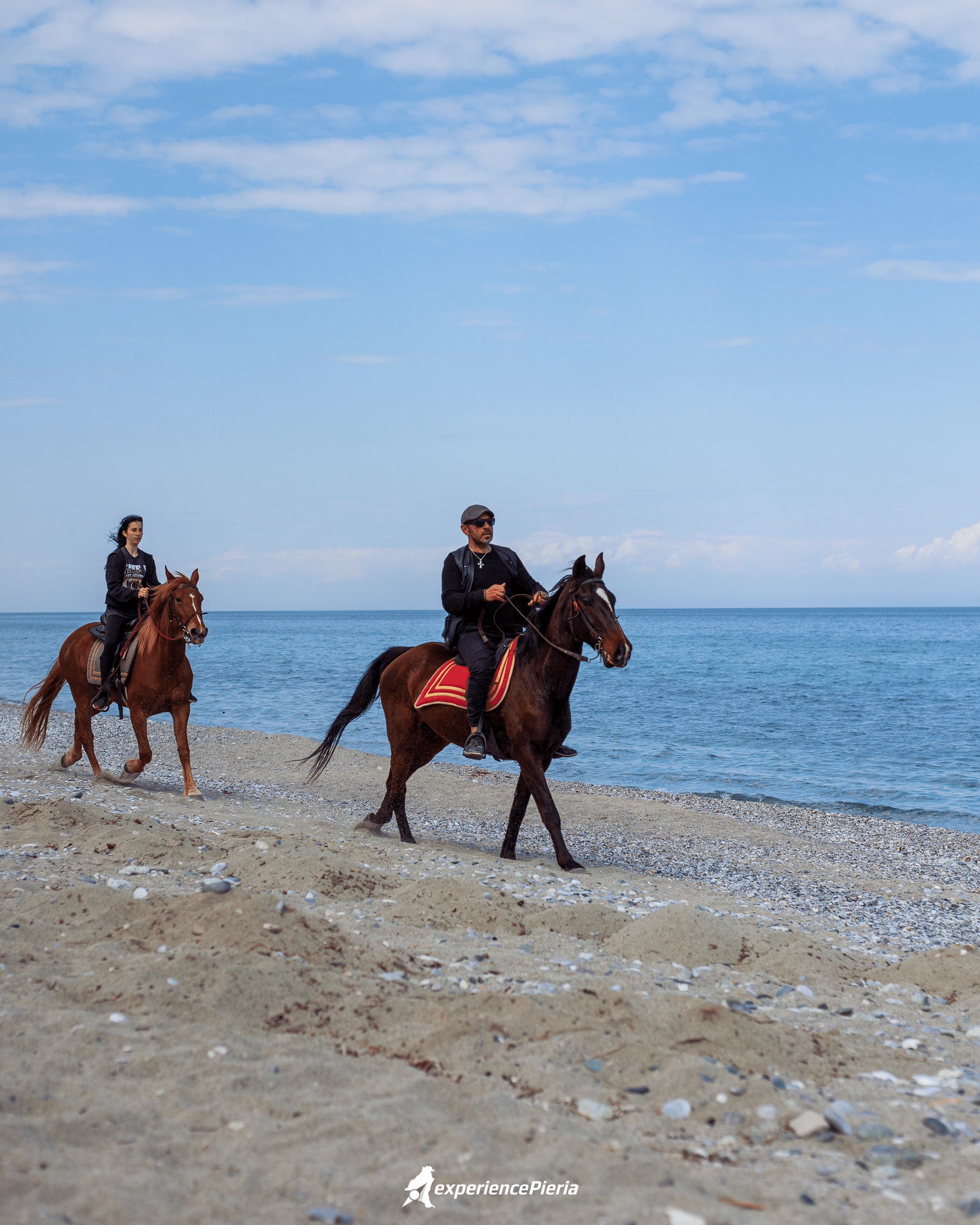 two persons riding 2 horses on Leptokarya's beach chore, best beaches in Pieria for riding horses.