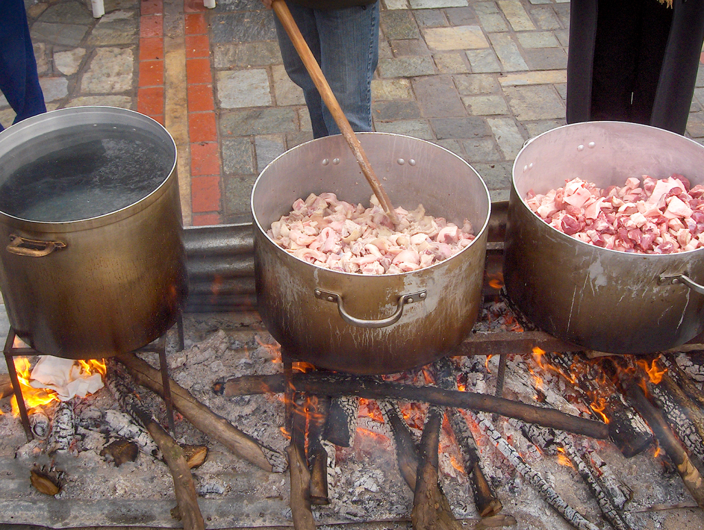 traditional greek method of frying pieces of pork with enough fat collected in containers instead of oil. Tsigaridas festival