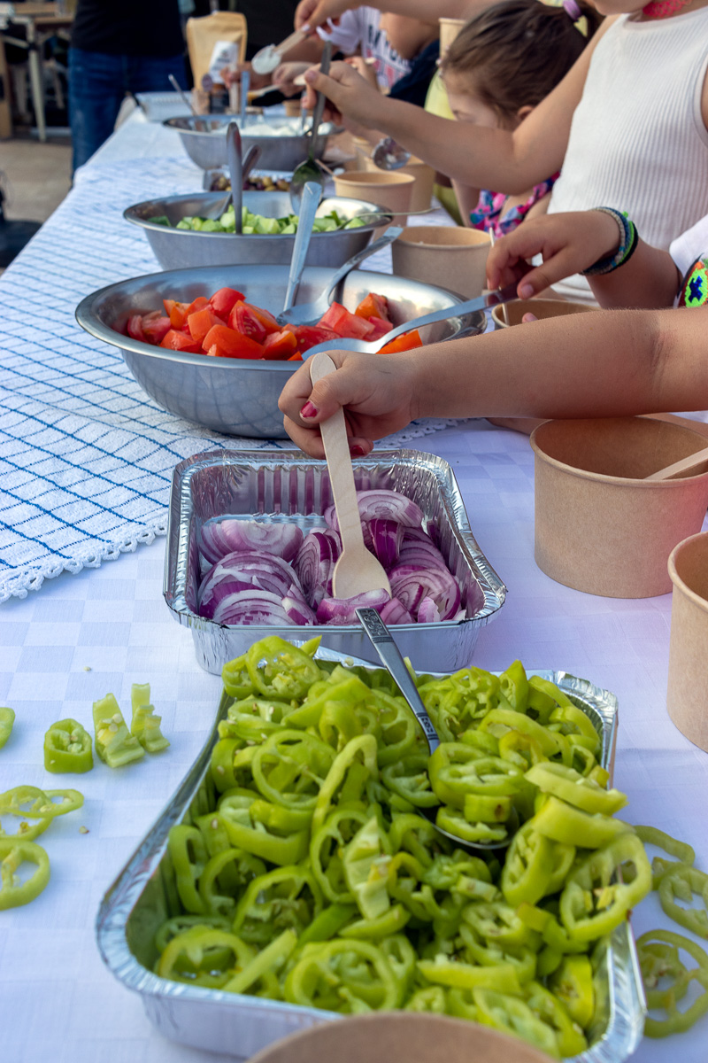 Children hands with fresh vegetables at Gastronomy Festival Pieria