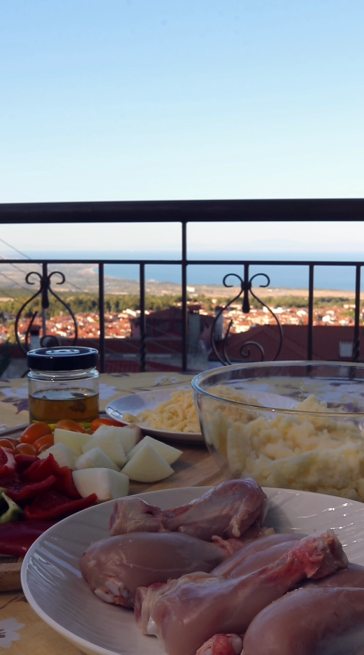 Balcony table in Litochoro with fresh ingredients and a view of the sea