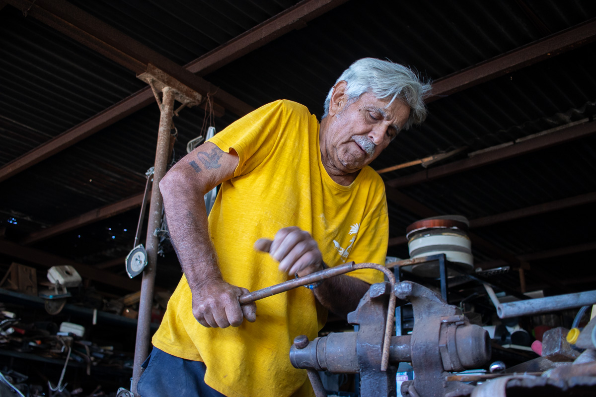 Man at flea market bending metal