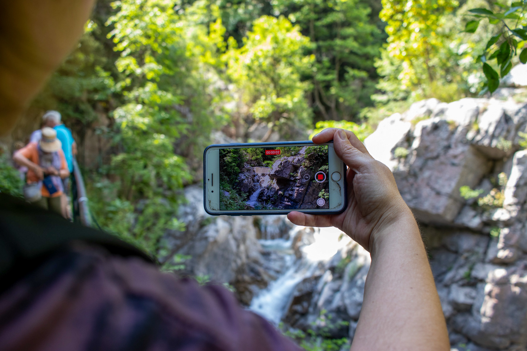 Zeus Bath — a visitor filming the waterfalls of Enipeas