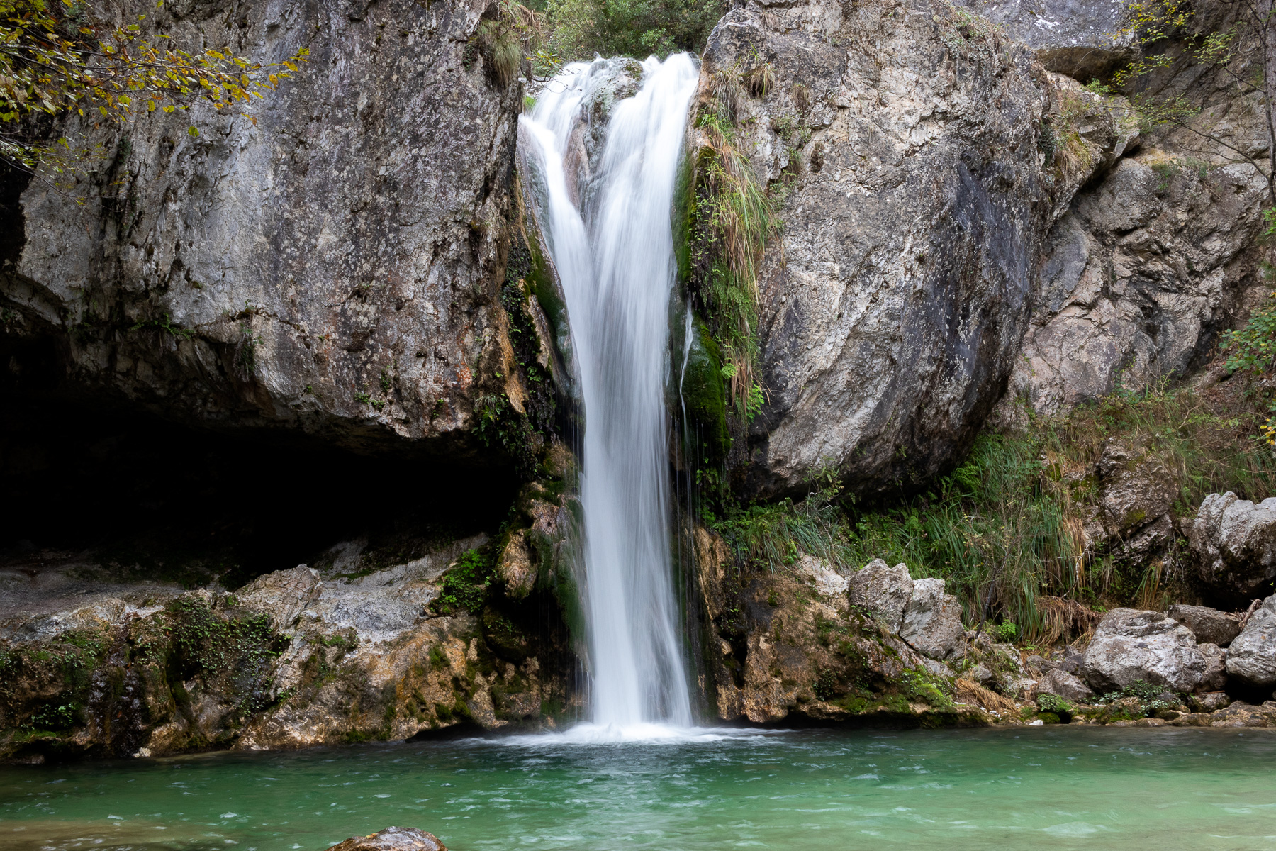 Orlias waterfall surrounded by rocks and autumn forest on Mount Olympus in Pieria
