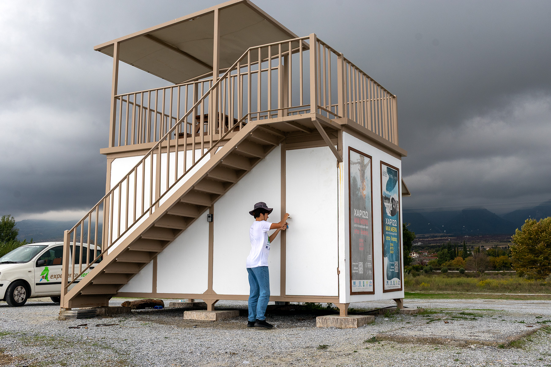 Anna locking the fire lookout observation post at Plaka Litochoro beach, with Mount Olympus behind, Pieria Greece