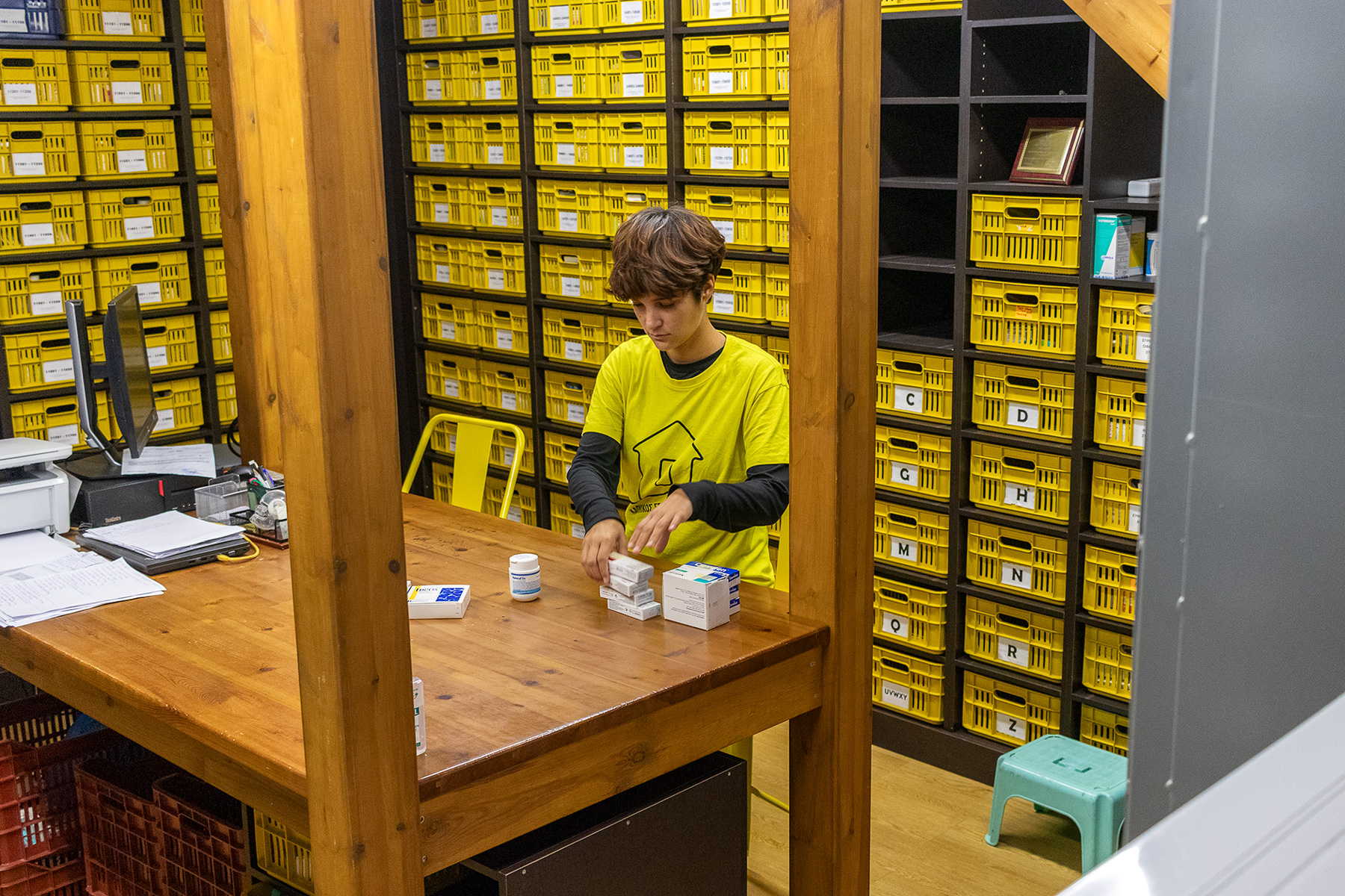 Volunteer sorting donated medicine in Kapnikos Stathmos Social Pharmacy, Katerini, Pieria Greece