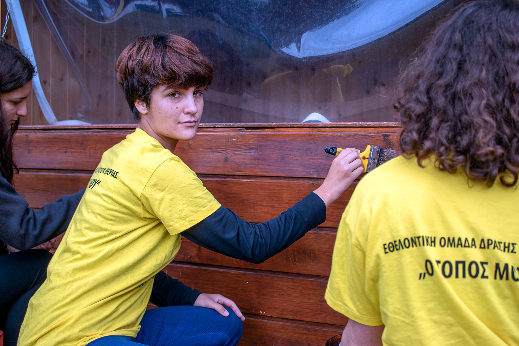 Volunteers repainting wooden houses at Kapnikos Stathmos, Katerini Pieria Greece