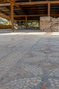 Archaeological mosaic floor beneath a protective roof at the Louloudies Episcopal Complex in Pieria.