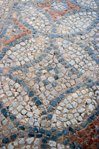 Detail of a geometric mosaic floor made of small stone tesserae at Louloudies in Pieria, Greece.