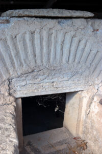Low stone-framed recessed opening among the archaeological remains at Louloudies, Pieria.
